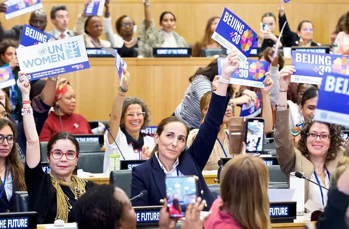 Participants hold up Beijing+30 signs during the high level side event to kickoff Beijing+30, held during the 79th Session of the United Nations General Assembly on 21 Sept 2024 at UN Headquarters in New York.