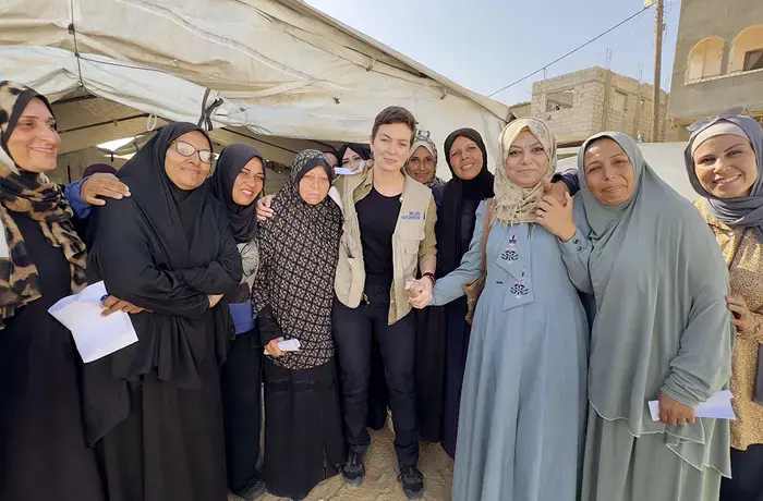 The “Smile of Hope" is run by AISHA, a UN Women partner and women-led-organization that provides, among other services, case management and protection support for displaced female cancer patients. Standing together during a visit to assess the women’s needs are Reem Frainah, AISHA's director (in blue dress) and Isadora de Moura, head of the UN Women Gaza sub-office (in vest). Photo: UN Women/Sulaiman Hejji