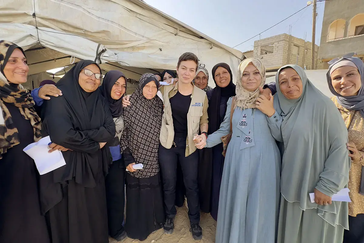 The “Smile of Hope" is run by AISHA, a UN Women partner and women-led-organization that provides, among other services, case management and protection support for displaced female cancer patients. Standing together during a visit to assess the women’s needs are Reem Frainah, AISHA's director (in blue dress) and Isadora de Moura, head of the UN Women Gaza sub-office (in vest). Photo: UN Women/Sulaiman Hejji