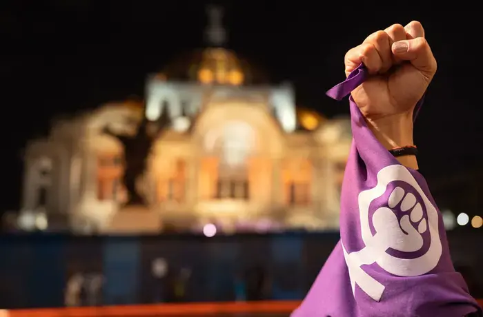 Palace Of Fine Arts in Mexico City (with raised fist and purple bandana of the women’s movement)